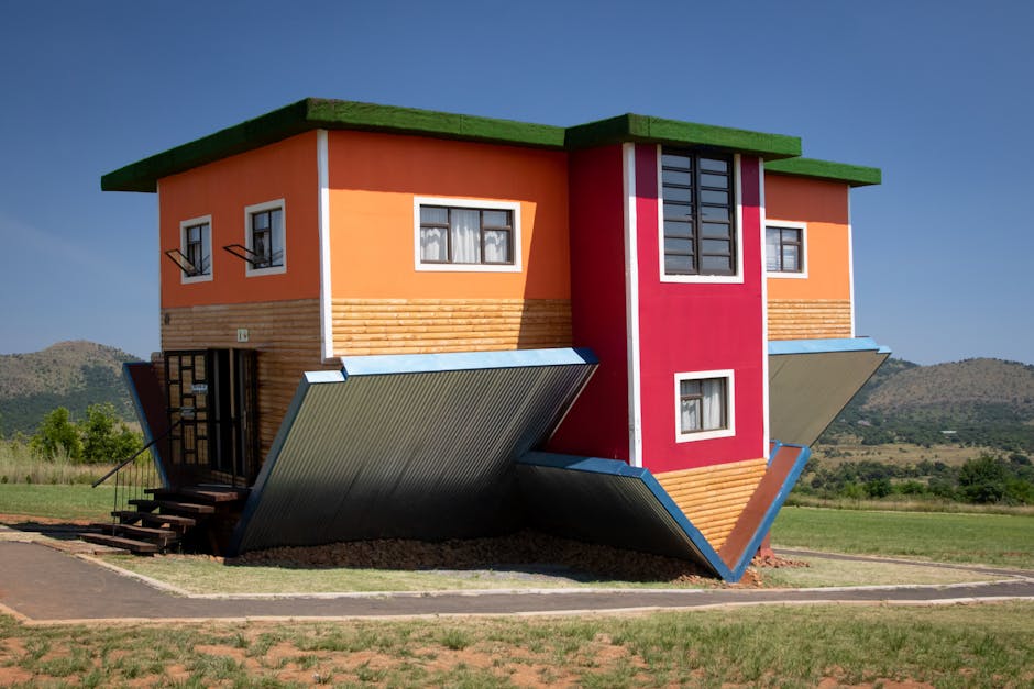 Colorful upside down house in Hartbeespoort, South Africa amidst scenic landscape.